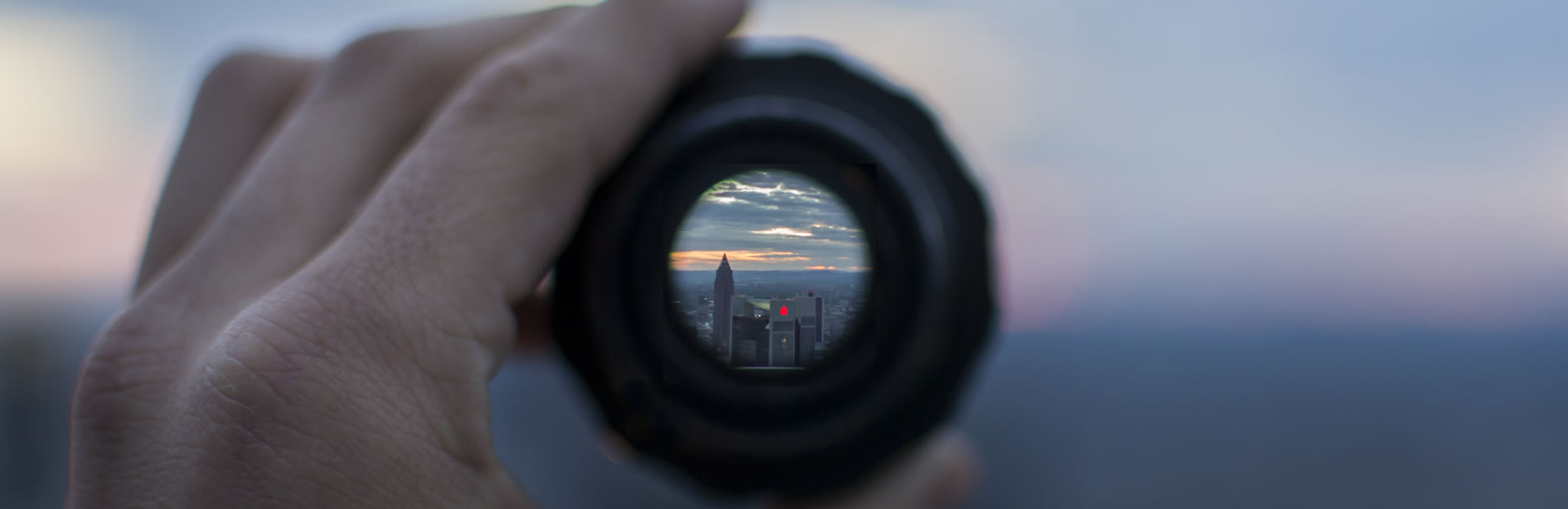 view of skyscrapers from the lens of a telescope