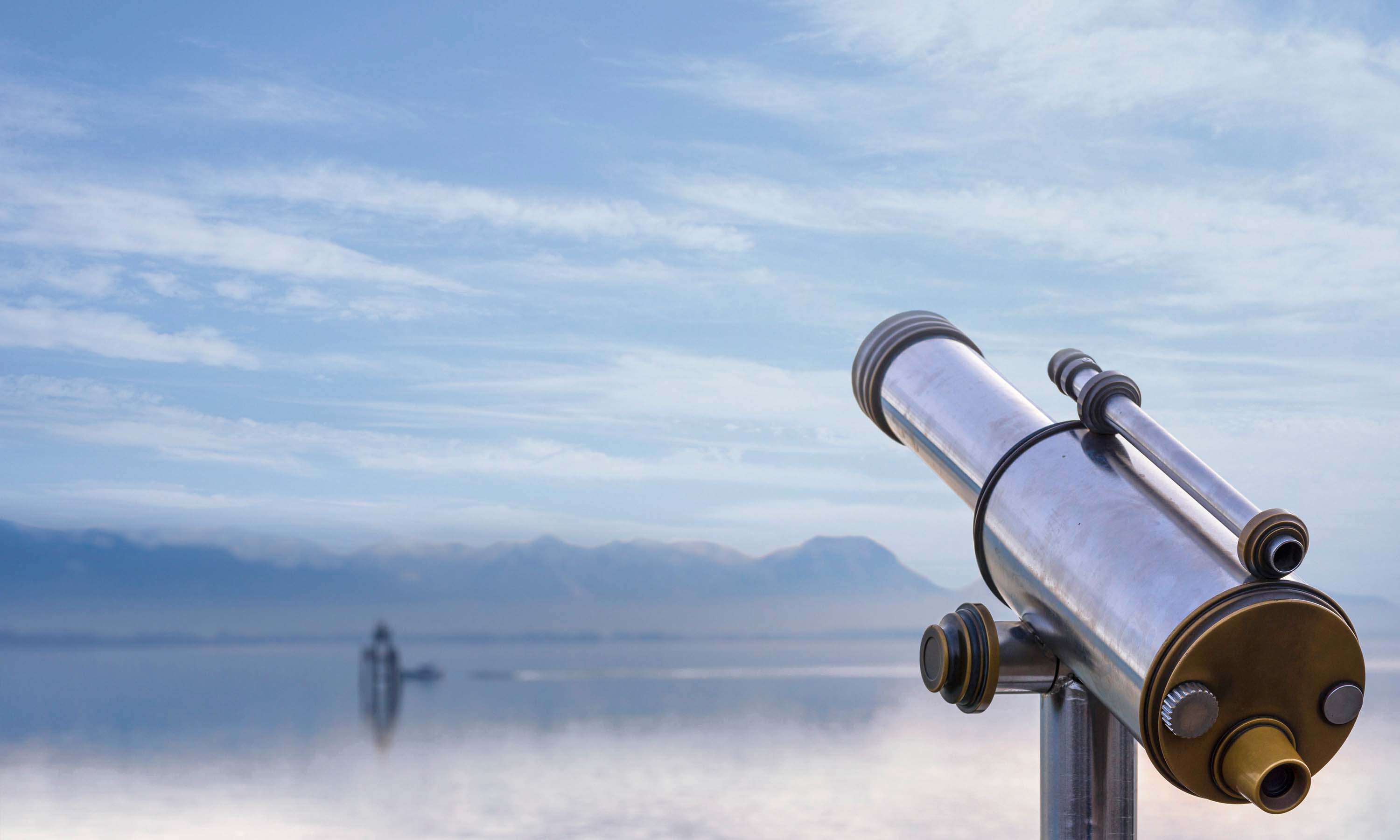 A telescope overlooking a lake.