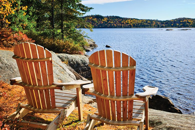 two-muskoka-chairs-overlooking-lake-in-page