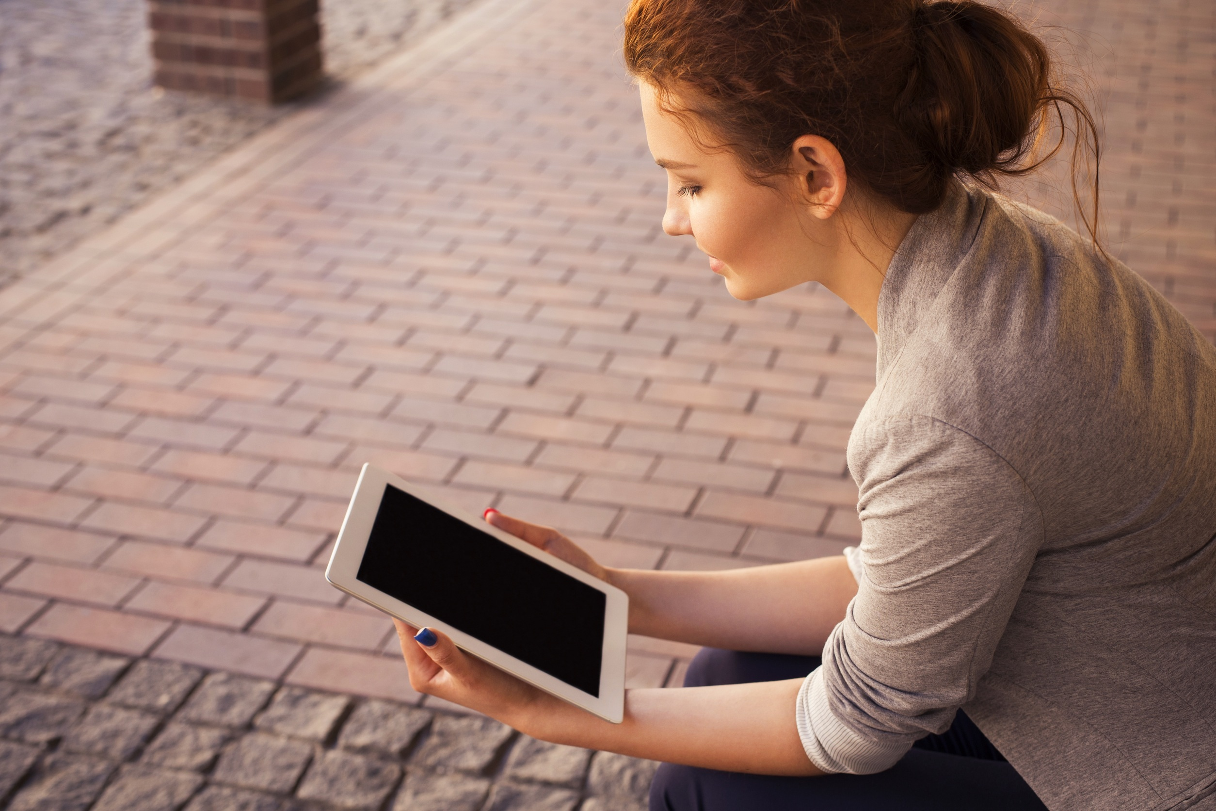 Woman reading from a tablet