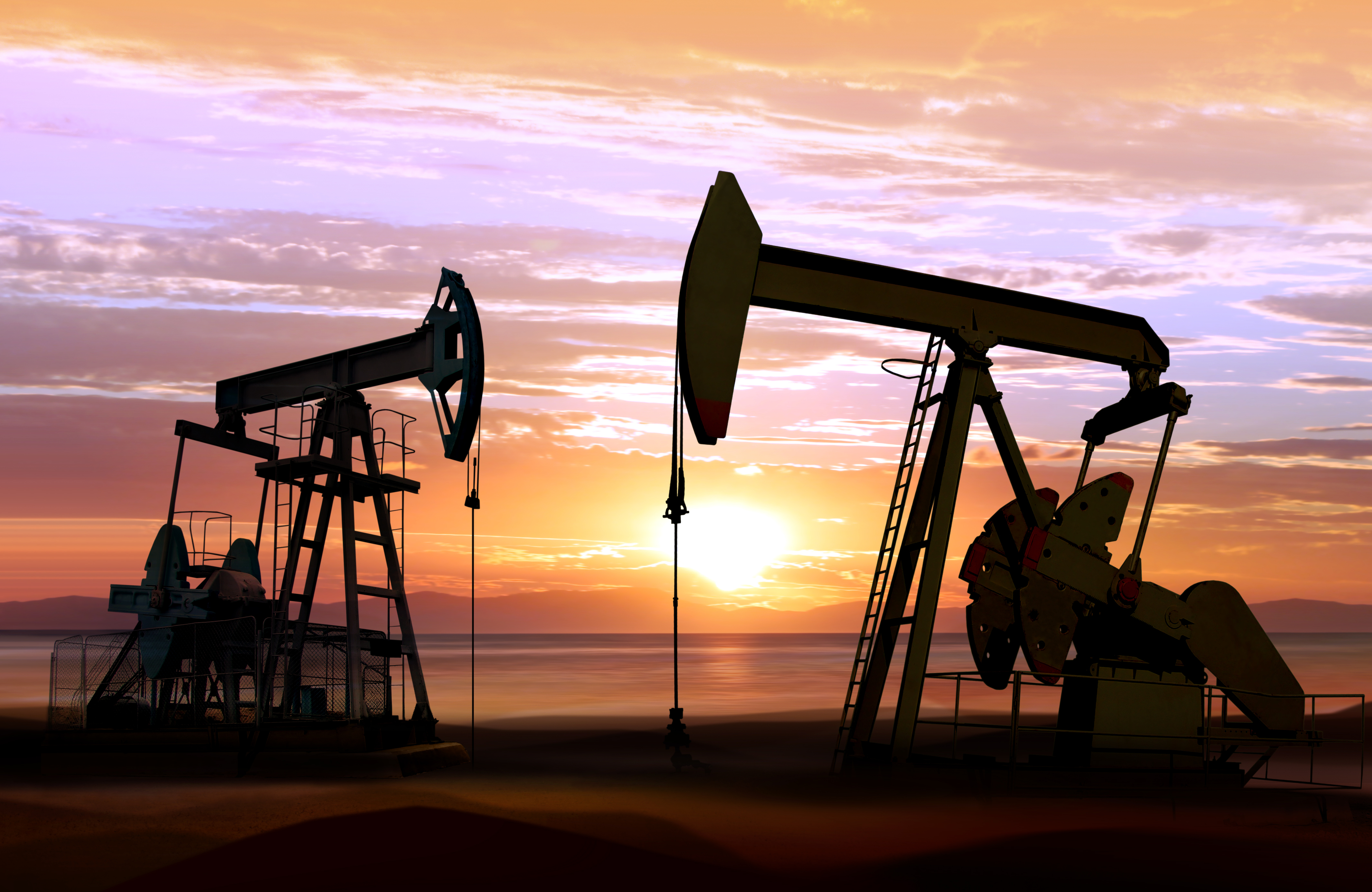 oil pumps at sunset sky background