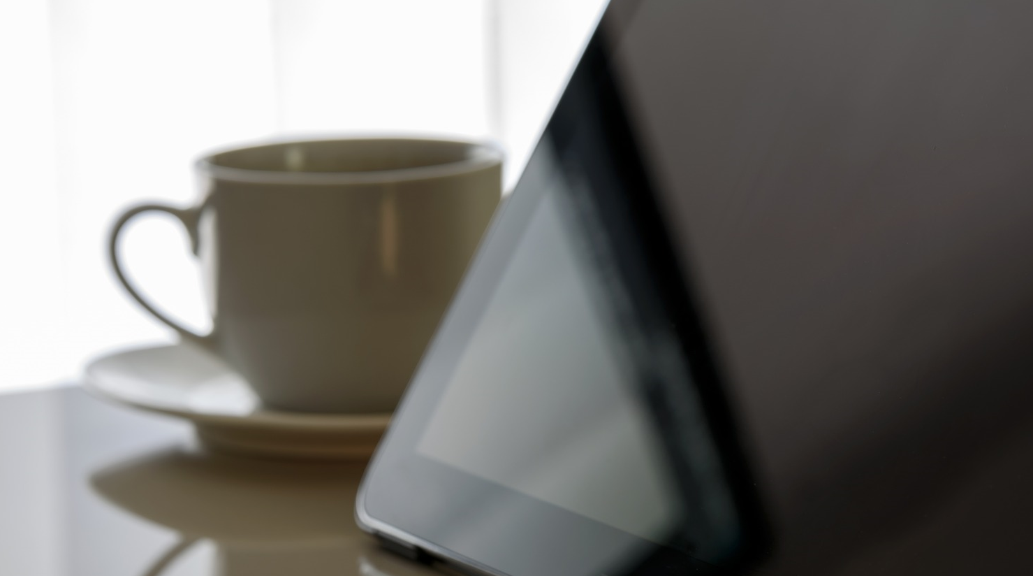Tablet and tea cup on a desk