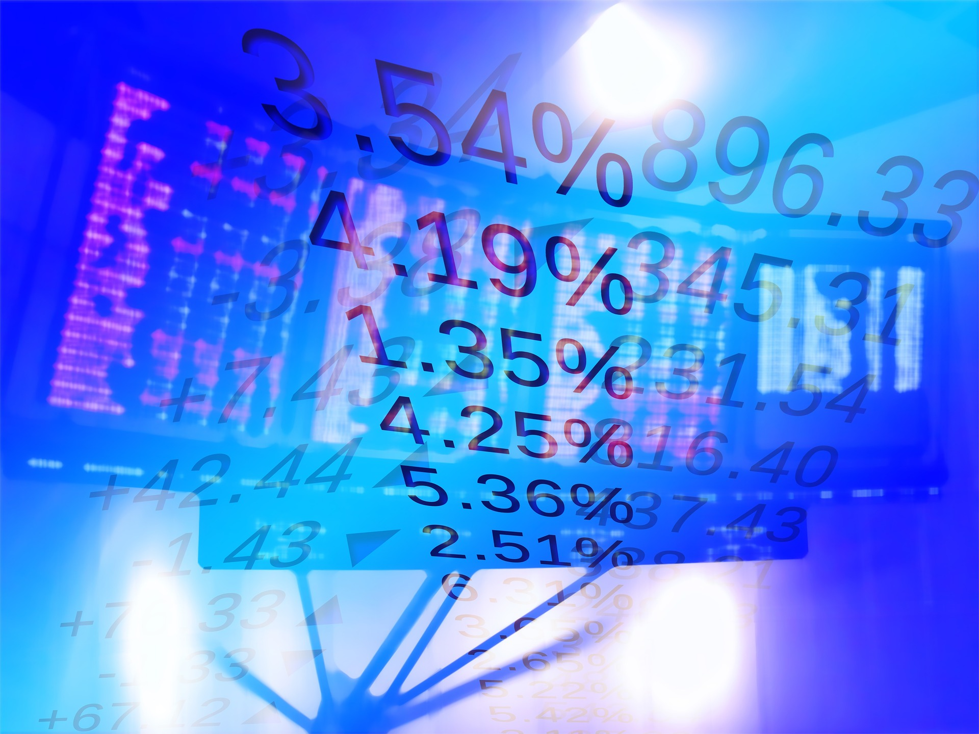 Blue screen with various numbers and percentages over a stock market ticker screen.
