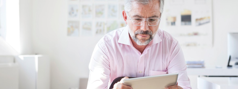 man reading paper planning for future