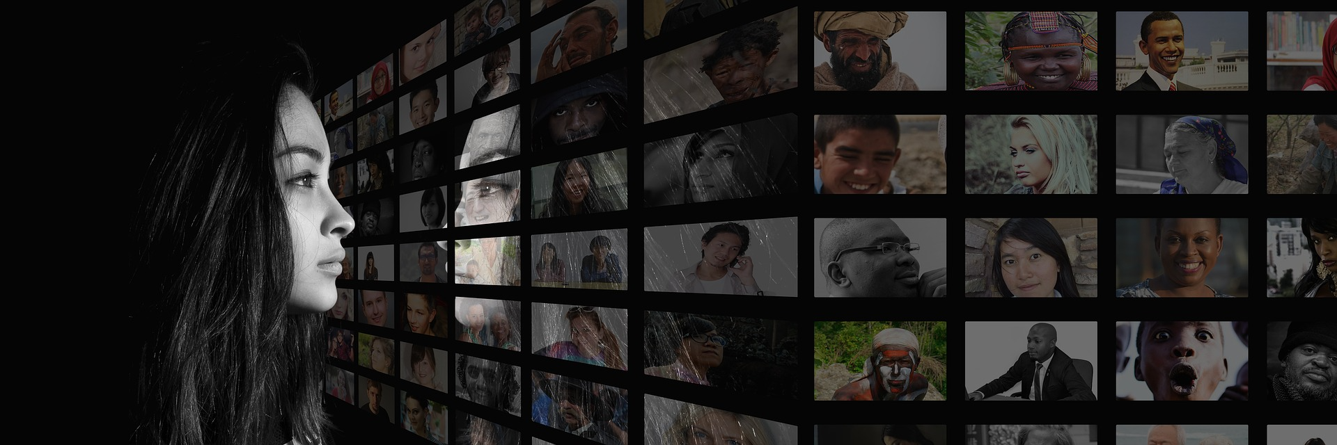 A women looking at a wall with multiple images of people.