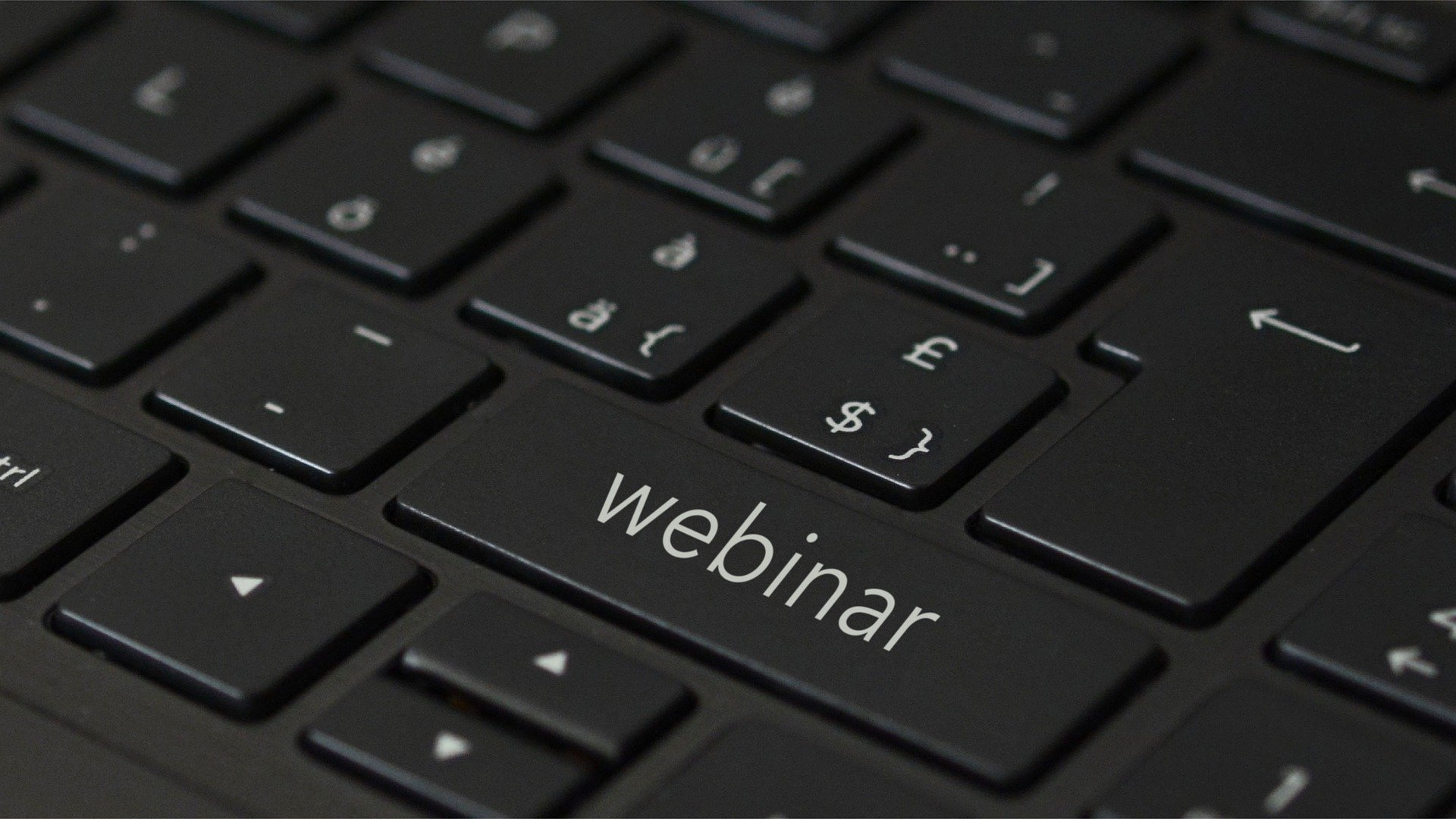 Close-up image of a key board. The text on the shift button has been replaced with Webinar