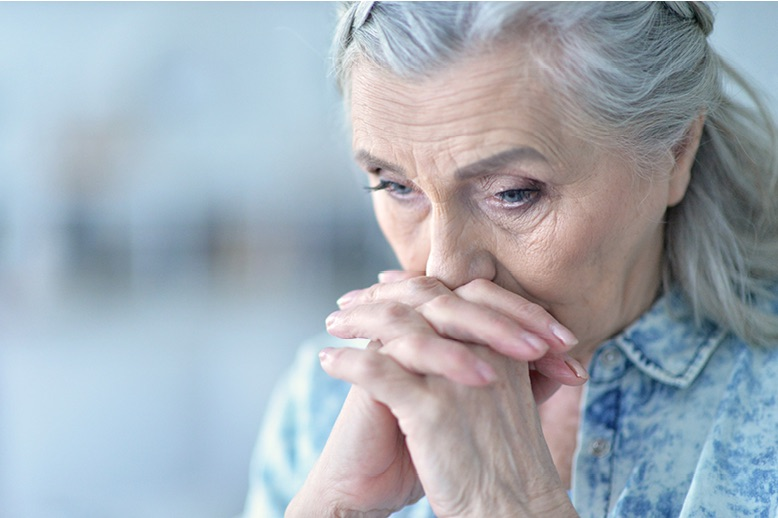 elderly woman lost in thought
