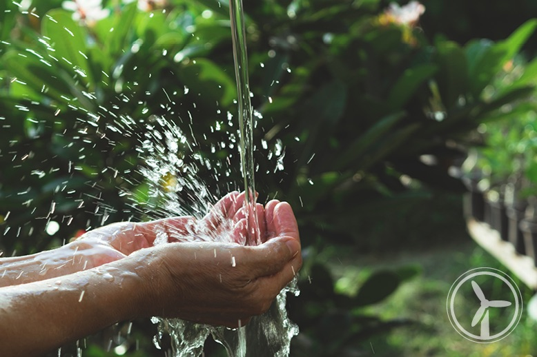 water-flowing-into-persons-hands-in-garden-in-page