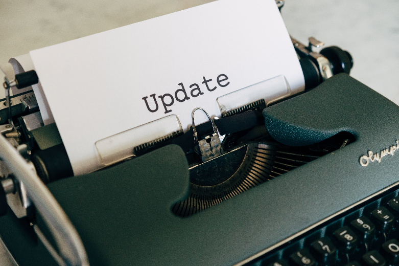 typewriter in page with the words update typed into the typewriter