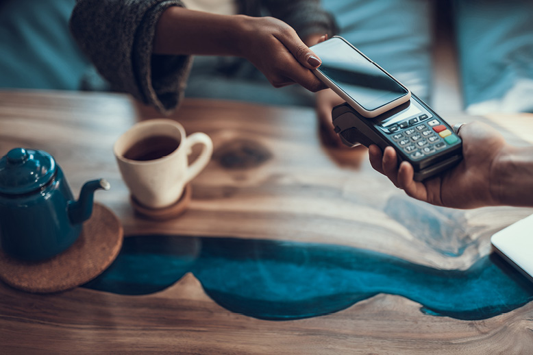closeup-of-woman-using-contactless-payment-with-smartphone-in-page