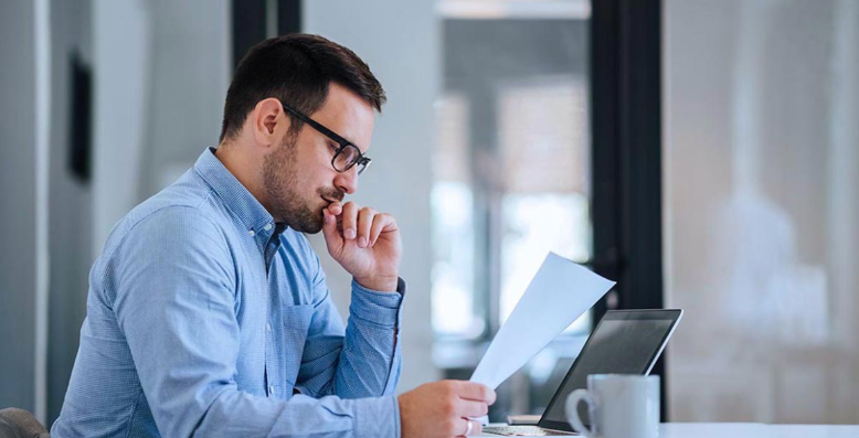 physician looking at work in page