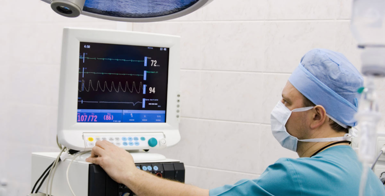 doctor looking at heart monitor in page