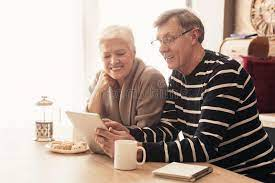 mature couple in kitchen discussing finances over coffee