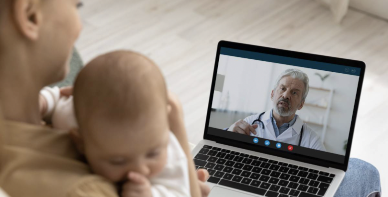 woman with baby on virtual call with physician