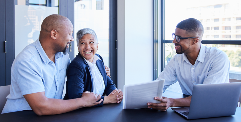 group of people smiling around a table
