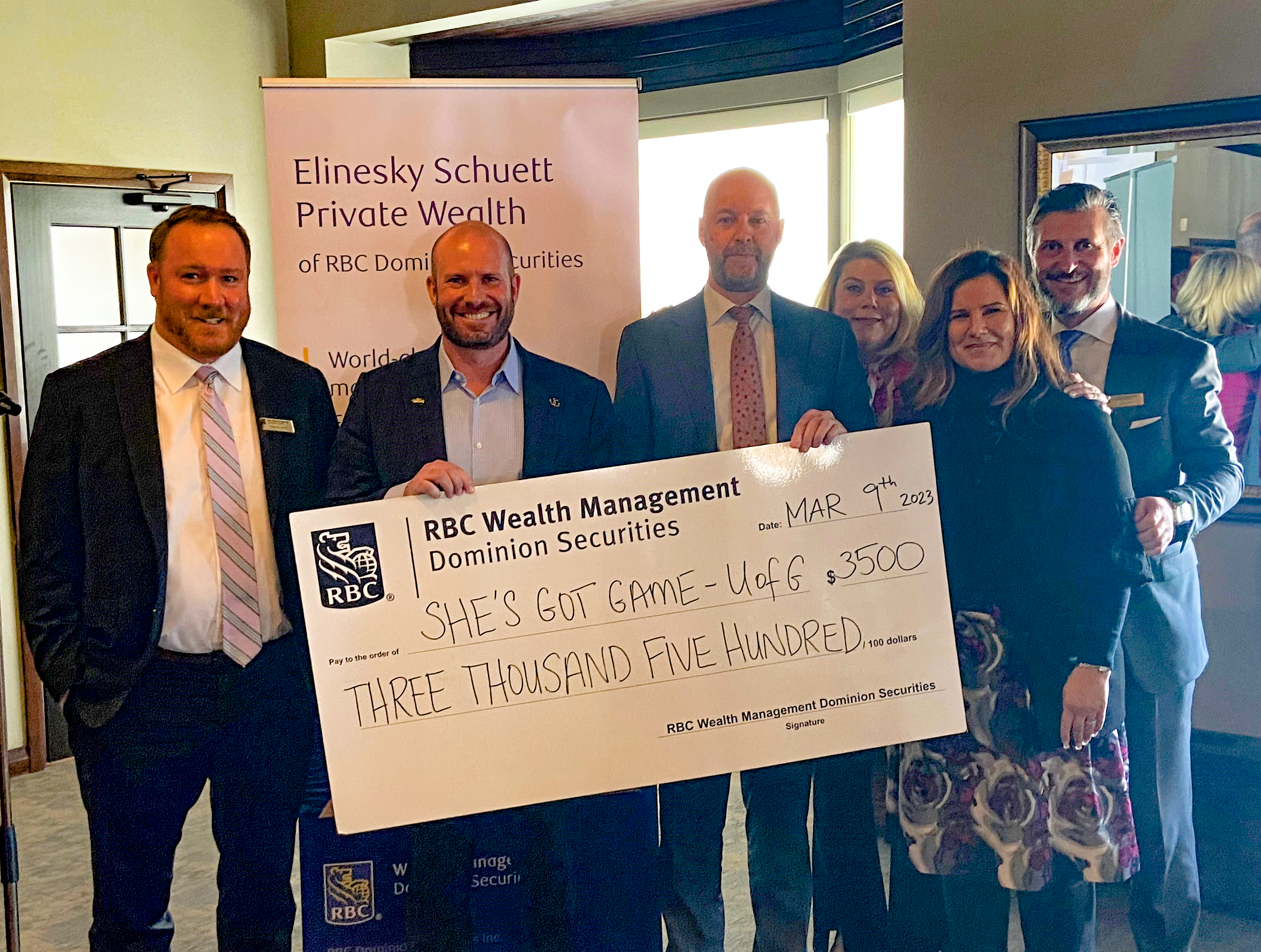 Elinesky Schuett Private Wealth team presenting a cheque