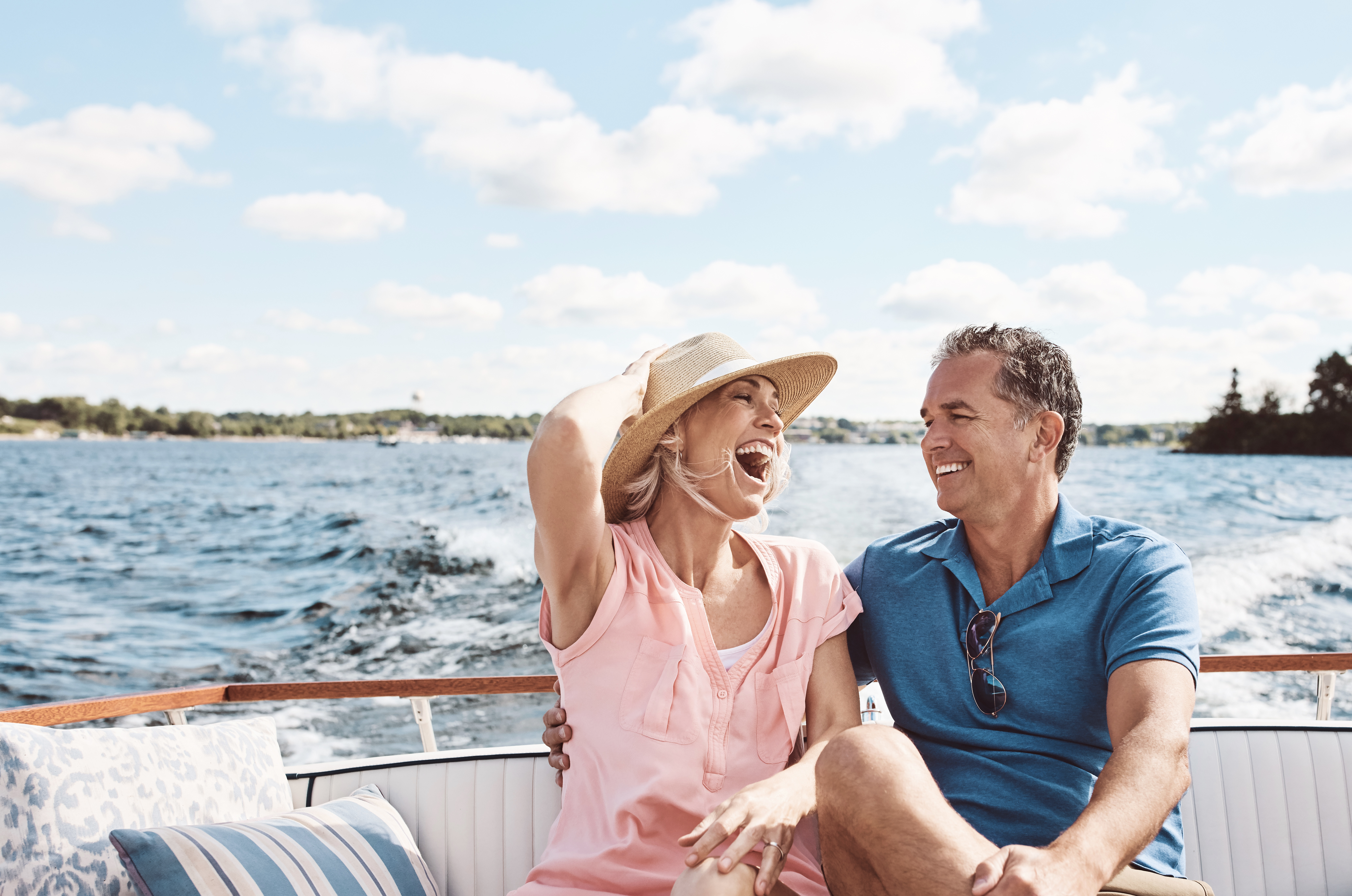 Couple laughing on boat on lake