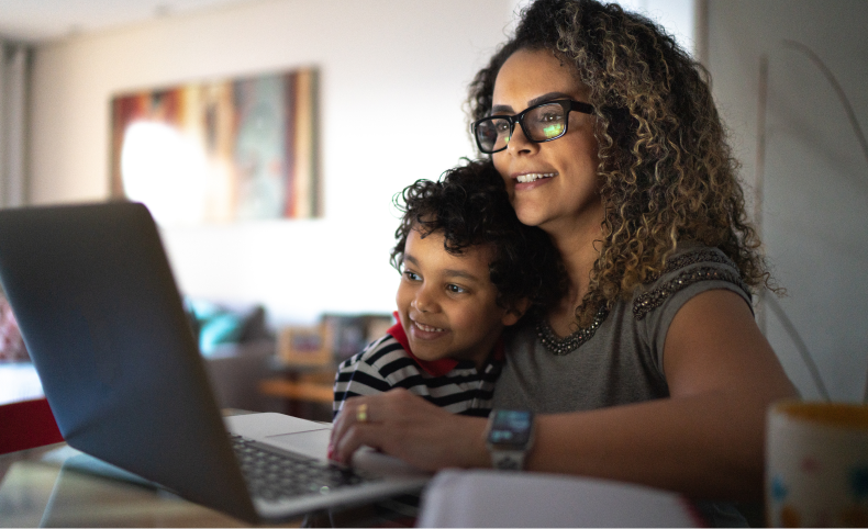 Mom and son looking at a computer.