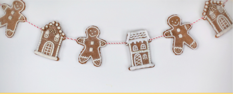 A string of gingerbread men and gingerbread houses on a white background