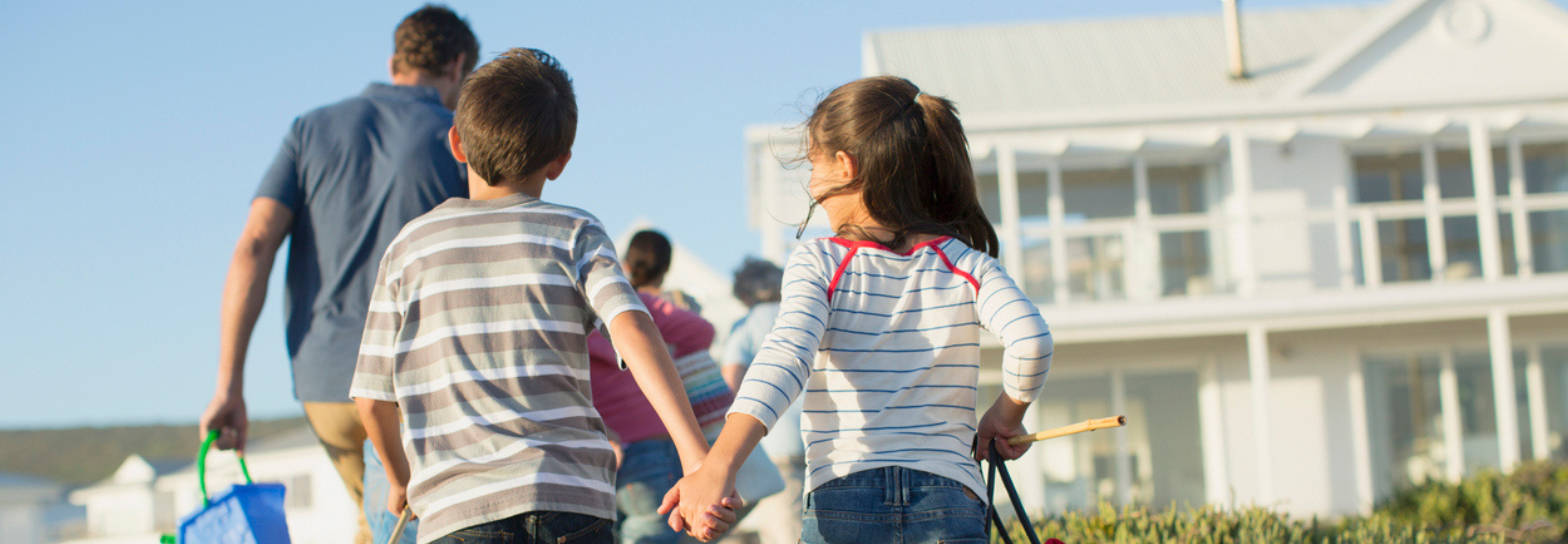 family walking back from the beach