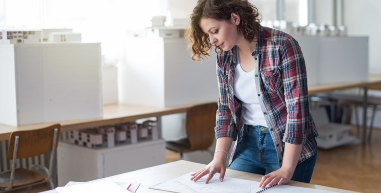 woman business owner looking at plans
