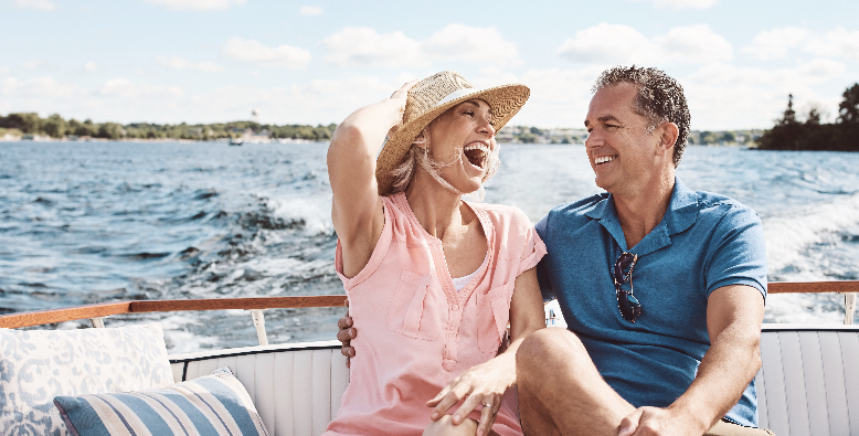 couple laughing on a boat on lake