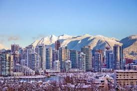 Vancouver city line behind snowy mountains