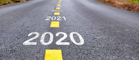 Picture of a road with yellow dotted lines. In between each dot is the following text, 2020, 2021, 2022