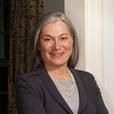 Picture of a woman with grey hair in a grey suit