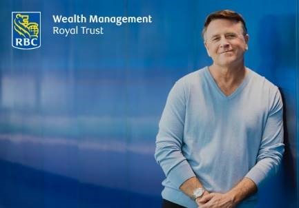 Man in a sweater leaning against a blue wall. RBC Wealth Management Royal Trust logo in top left corner