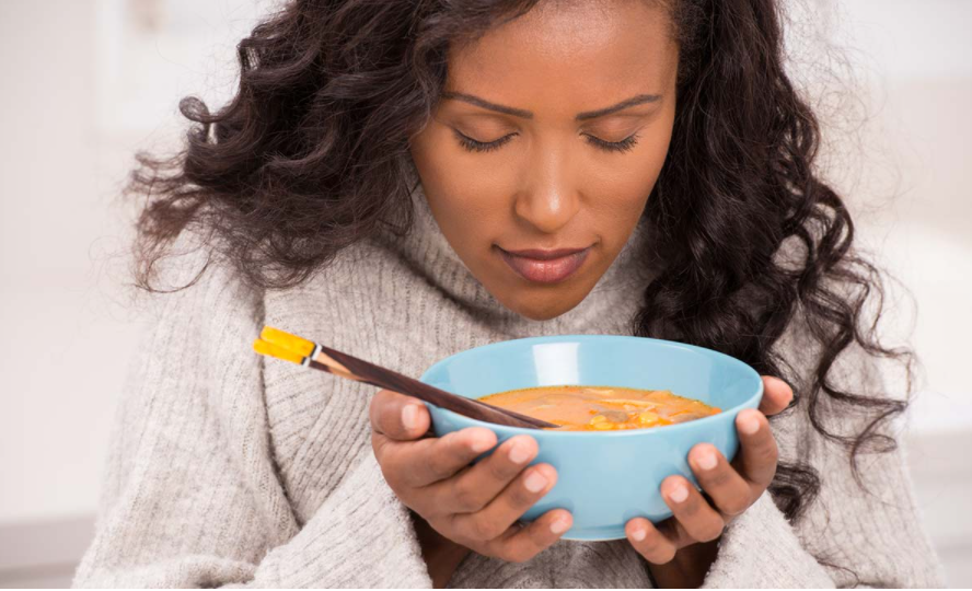 Woman enjoying a bowl of soup