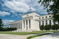 Photo of the US Federal Reserve. Large white concrete building 