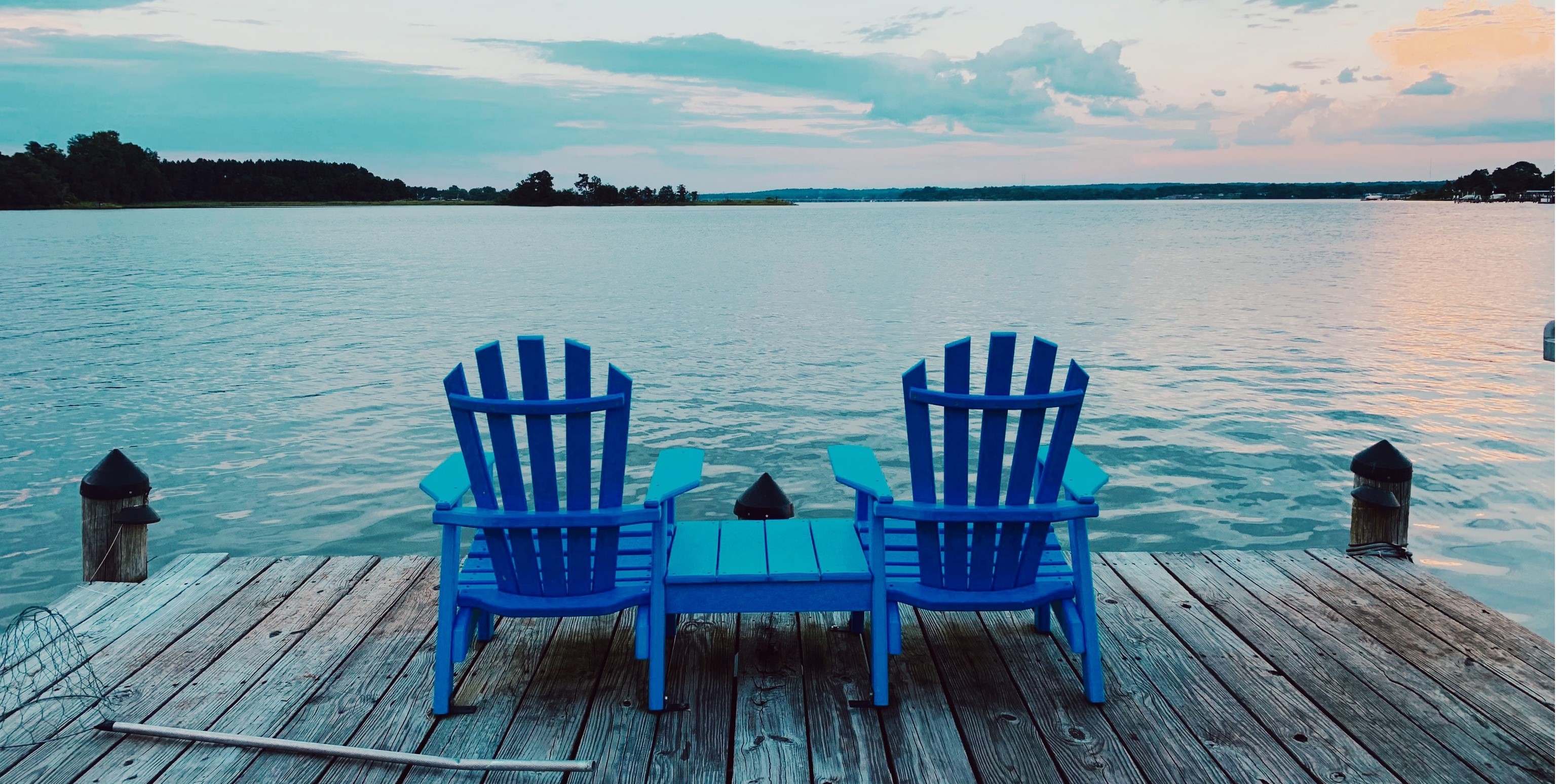 Blue Muskoka chairs on a dock