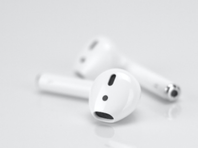 Earbuds on a grey background