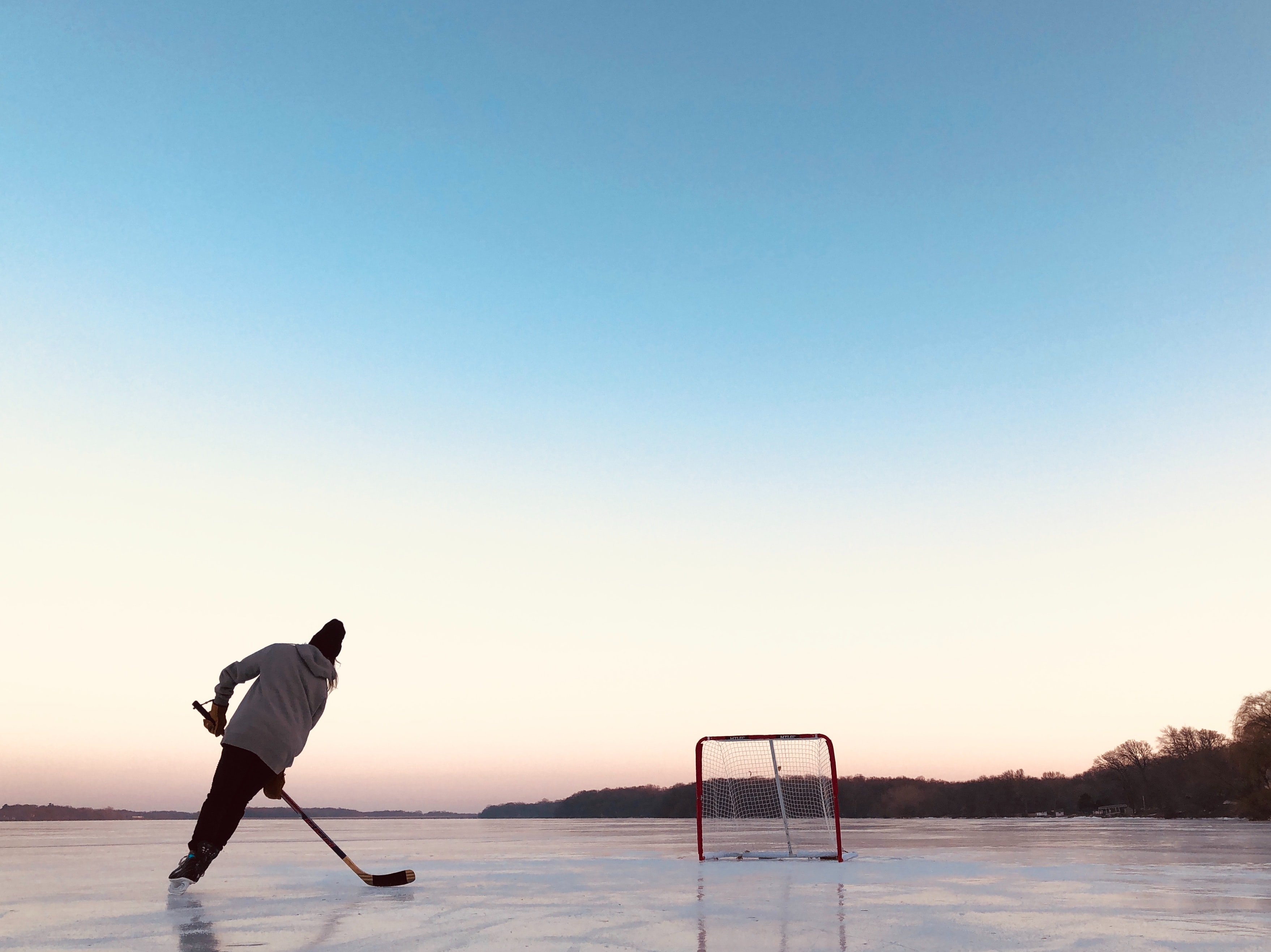 outdoor rink with kids playing hockey in page