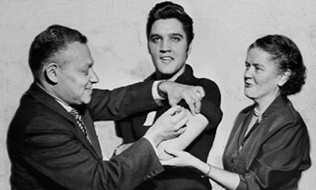 Elvis Presley receives a polio vaccination from doctors at the CBS studios, New York, in 1956. Photograph: Seymour Wally/NY Daily News via Getty Images