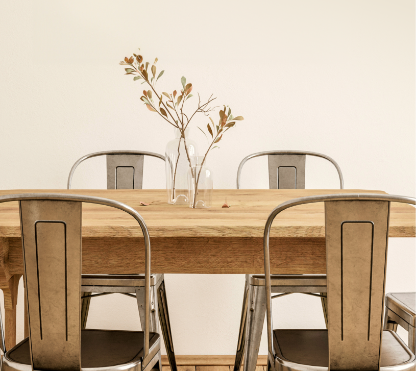 Metal chairs around wooden table.