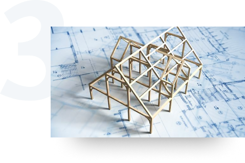 Framework of a model house built on top of blueprints.