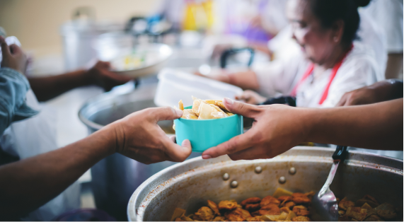 Handing out bowl of food at a foodbank