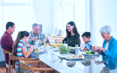 A multigenerational family gathered around a table for dinner.