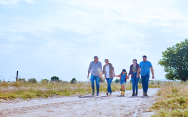 A multigenerational family walking on a trail.