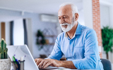 A man reading on his laptop.