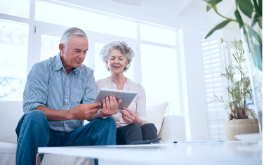 A couple looking at a tablet.