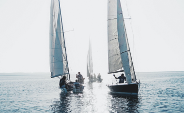 three sailboats on the water.