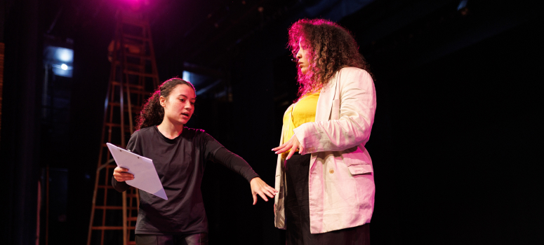 Young woman gives stage direction to a performer