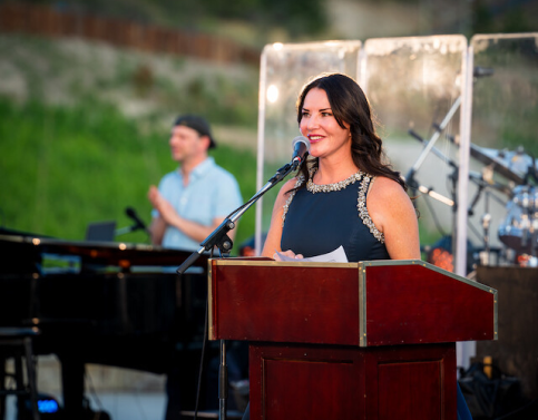 Rhonda Hymers giving a speech at the Once in a Blue Moon charity event.