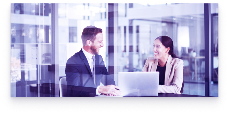 Two people working together on a laptop.