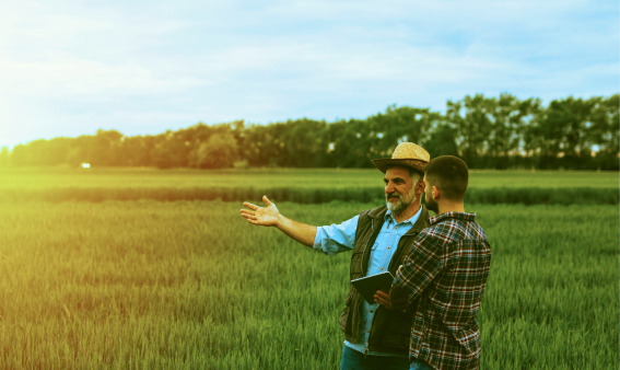 Two people standing in a field.