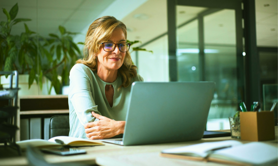 A woman working on a laptop.