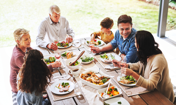 A family sitting at a table for dinner.